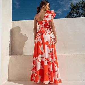 Detailed view of ruffle shoulder strap and vibrant floral print on beach vacation dress