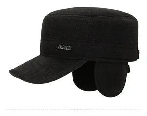 Side view of dark grey winter wool flat cap with ear flaps and JEANS embroidery