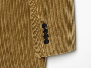 Close-up of mustard yellow corduroy sleeve detail with four black decorative buttons