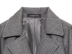 Macro detail of dark grey wool blend coat featuring notch lapel and premium inner lining