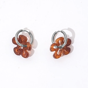 Close-up of hollow brown resin flower earrings with silver stainless steel hoops