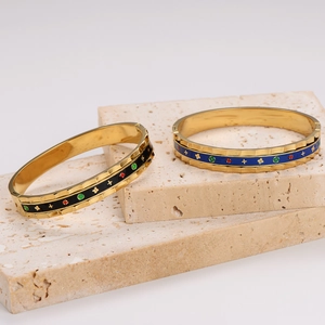 18K gold plated enamel bangle featuring vintage star and flower patterns on travertine stone