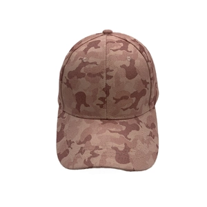 Close-up of reinforced stitching on the brim of a brown camouflage canvas baseball cap