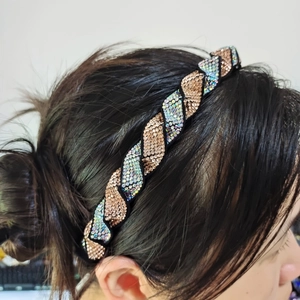 Detail of twisted headband with hand-set champagne and AB rhinestones on black fabric base