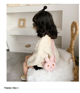 Pink plush bunny crossbody bag shown on a child model in a cozy indoor setting