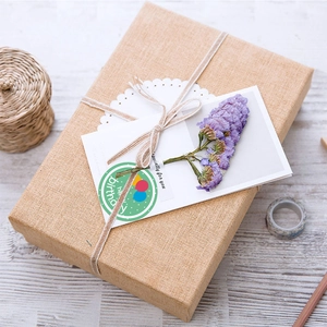 Detailed view of happy birthday seal sticker on a gift box decorated with dried flowers