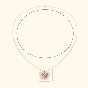Detailed macro view of the gradient butterfly pendant with gold chain and lobster clasp