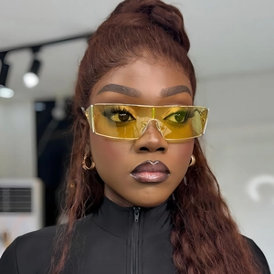 Futuristic oversized visor sunglasses with yellow tinted lenses and gold metal frames