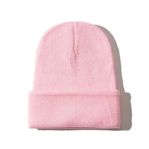Detailed knit texture of pink winter beanie showing elastic ribbed warmth material