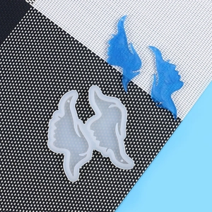 Detail view of bird wing silicone mold with blue resin heart puzzle finished pieces