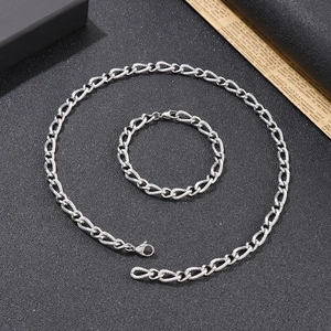 Polished silver snake chain necklace and bracelet set for men on black background