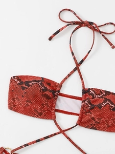 Detail of red python print halter bikini top with ruched texture and neck ties