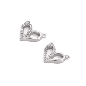 Detailed macro view of heart-shaped connectors with cubic zirconia and two loops
