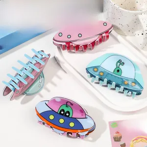 Detailed view of creative UFO acrylic hair claws with cute alien and cat illustrations