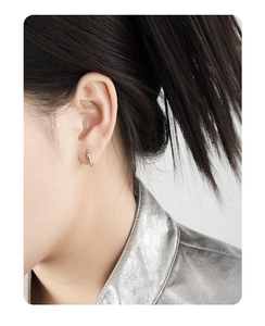 Close-up of minimalist S925 sterling silver hoop earrings with gold and silver finish