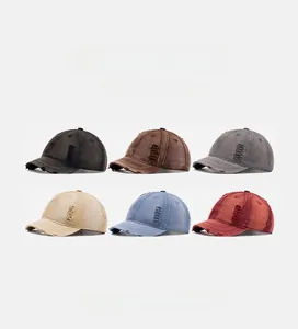 Detail view of vintage washed baseball caps in six colors with distressed hole accents