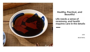 Close-up of a Japanese ceramic cat soy sauce dish on a wooden table with spices