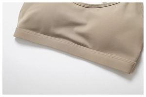 Detailed view of seamless beige sports bra showing high-elasticity fabric and flat seams