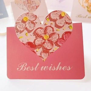Detailed view of pink heart cutout card with artistic floral oil painting interior