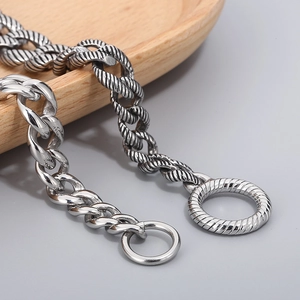 Detailed close-up of polished silver stainless steel curb and rope chain jewelry set