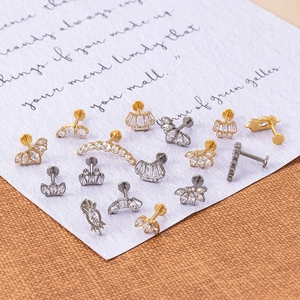Detailed view of F136 titanium marquise crown ear studs with inlaid zircon in gold and silver