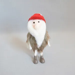 Close-up of handmade felt Christmas gnome with red knit hat and soft white beard