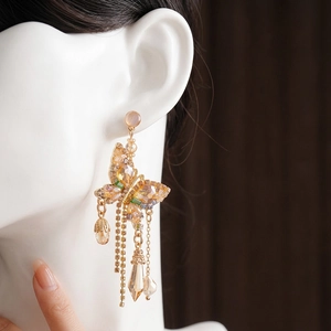 Boucles d'oreilles papillon en cristal avec de longues franges et pierres champagne