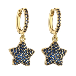 Detailed close-up of gold star earrings with micro-pave blue cubic zirconia crystals