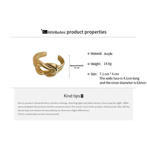 Macro view showing dimensions and weight of this wide gold acrylic crossover bangle