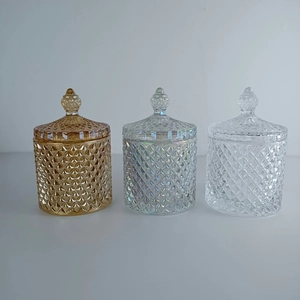 Detailed view of diamond-patterned crystal glass jars in amber, iridescent, and clear colors