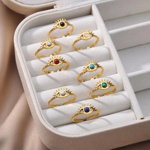 Detail of adjustable evil eye rings with colorful stone inlays and twisted rope bands