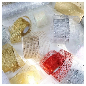Close-up of glitter chiffon ribbon rolls with mesh texture and sparkling sequins for DIY crafts
