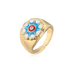 Detail of 18K gold plated adjustable ring with blue and white enamel floral pattern