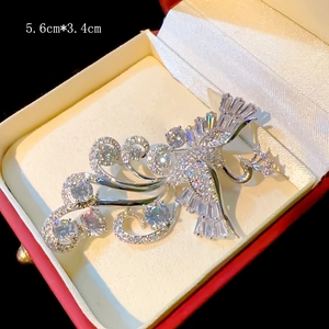 Detailed 5.6cm by 3.4cm phoenix brooch with silver tassels and clear gemstones