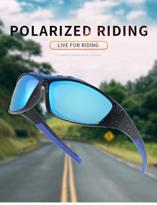 Polarized riding sunglasses with blue lenses floating over a blurred highway background