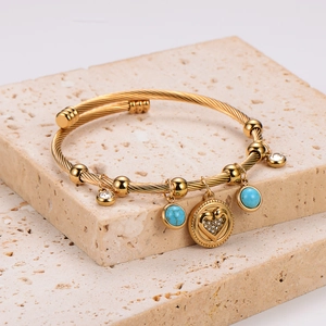 Bohemian gold plated stainless steel open bangle with turquoise bead and heart charms