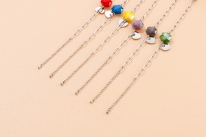Detail of adjustable stainless steel heart charm bracelets in six colorful beaded styles