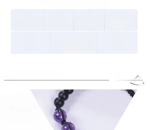 Macro detail of 12mm amethyst and tiger eye stone beads on handwoven bracelet