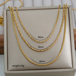 Three-layer gold plated stainless steel necklaces featuring curb, rope, and snake chain styles