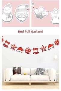 Detail of red bronzing Christmas banner hanging above a white sofa in a cozy living room