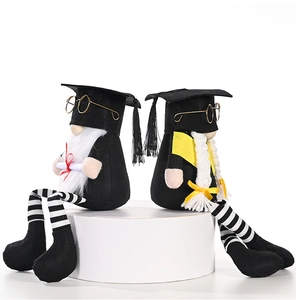 Close-up of graduation gnomes with tassels, glasses, and certificates on white base