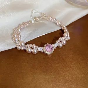 Double-layer pearl bracelet with pink oval gemstone and sparkling zircon accents