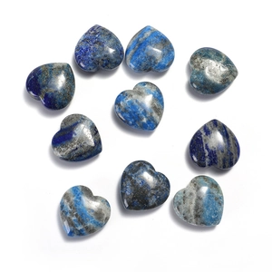 Flat lay of polished heart-shaped lapis lazuli stones with natural golden mineral textures