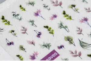Macro shot of 5D botanical leaf stickers in green and purple on textured paper