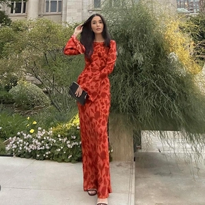 Detail of red floral print maxi dress featuring long sleeves and a slim fit silhouette