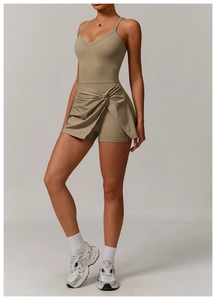 Close-up of the knot design and crossover detail on this green tennis dress