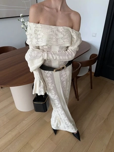 Close-up of off-white hollow-out knit dress showing intricate texture and fabric detail