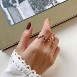 Detailed view of irregular organic S925 silver rings in gold and silver finish
