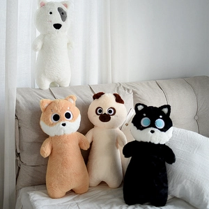 Detailed view of four colorful long plush dog pillows in a cozy bedroom setting