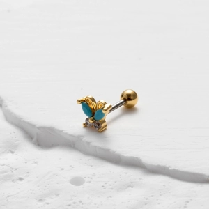 Detailed close-up of golden butterfly cartilage stud with blue turquoise and small crystals